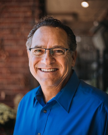 Headshot of Kent Miracle in Blue Polo Shirt